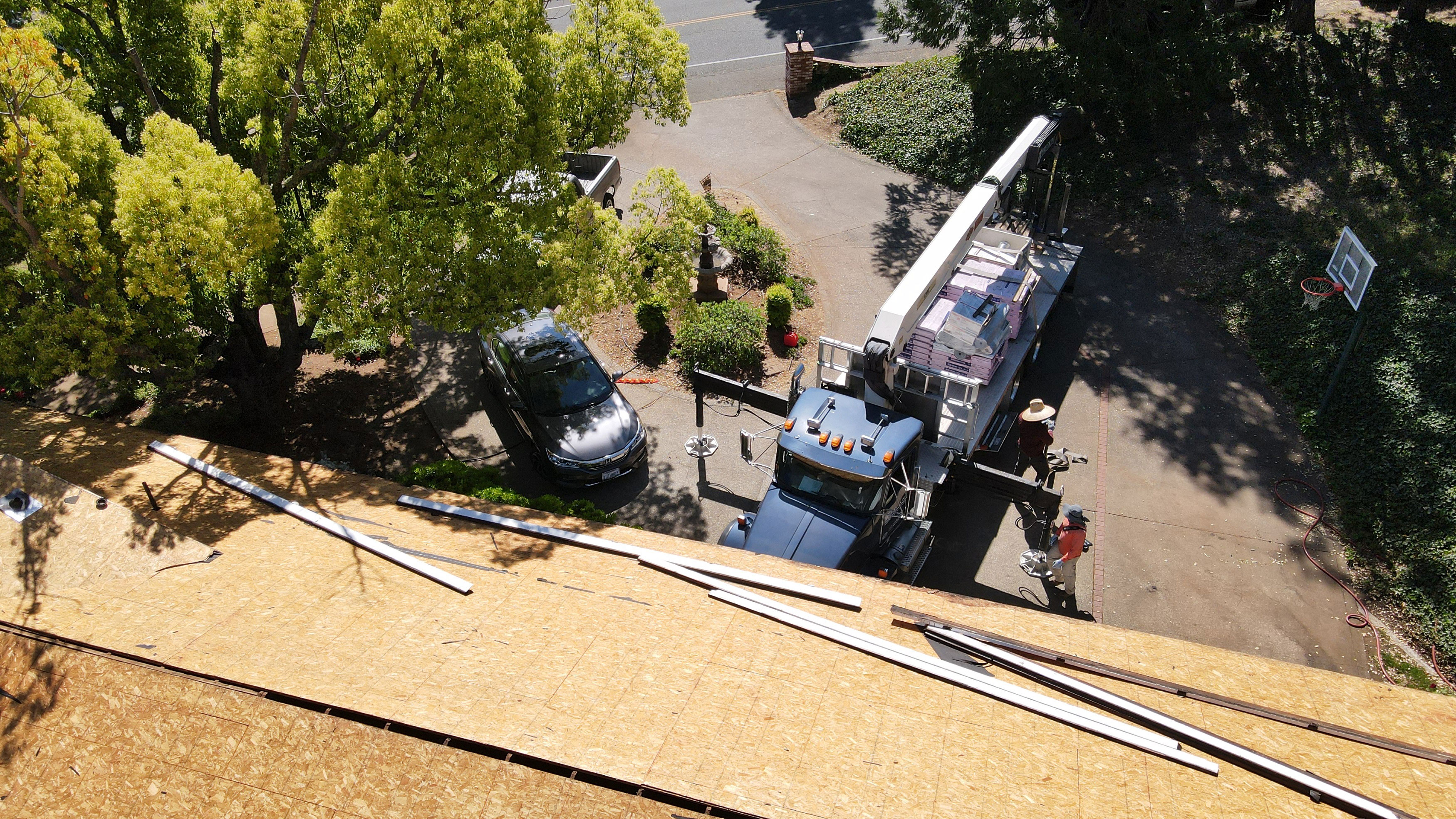 A construction site with a crane and building materials on a sunny day.