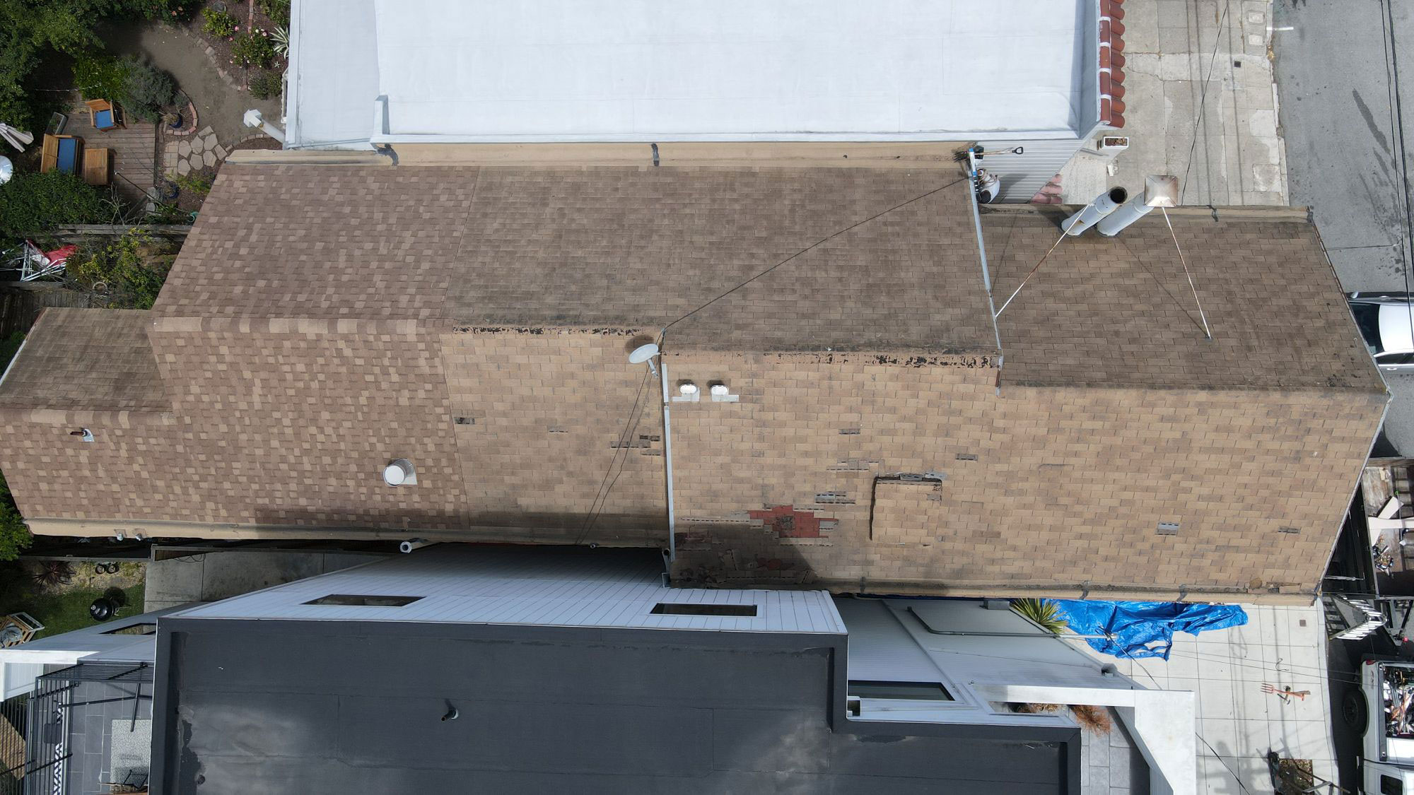 The image shows a building with a partially completed roof under construction.