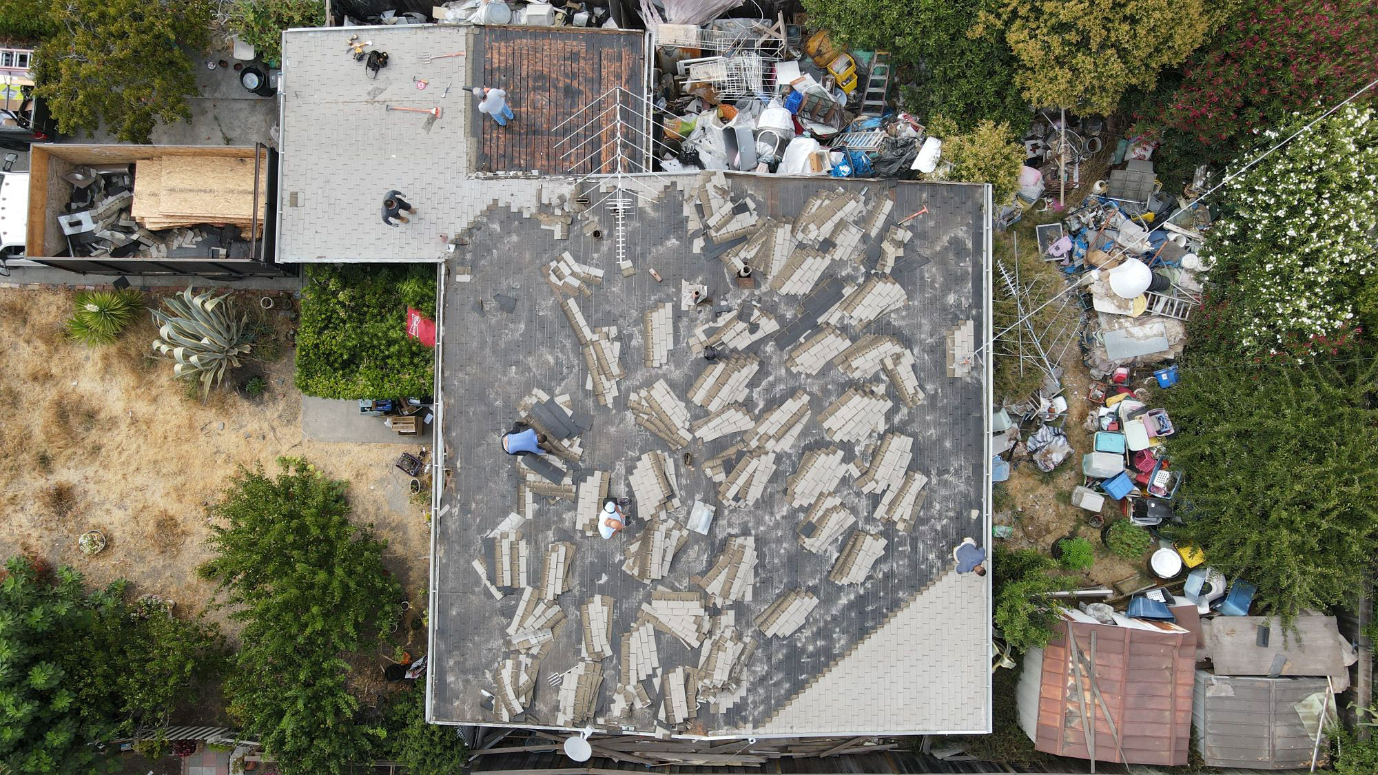 The image shows a large open area with debris scattered across its surface, indicating recent demolition or construction activity.