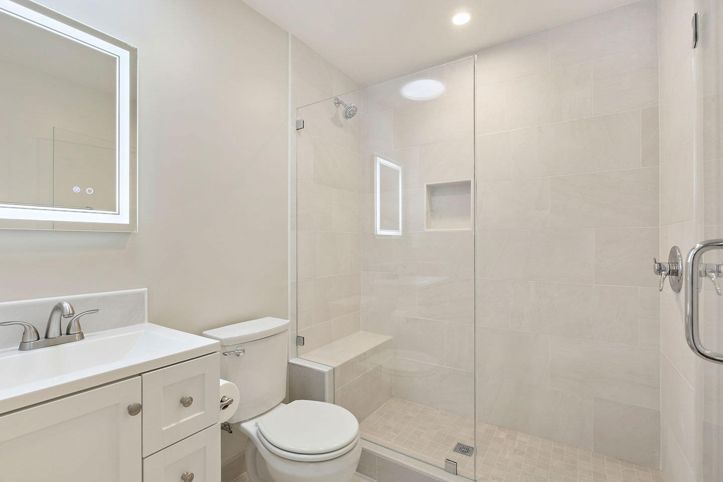 The image shows a modern bathroom with a white color scheme, featuring a walk-in shower, toilet, sink, and mirror.